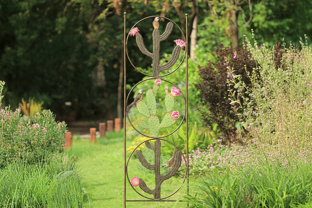 cast metal trellis with circles and cacti motifs with birds as design set in graden space