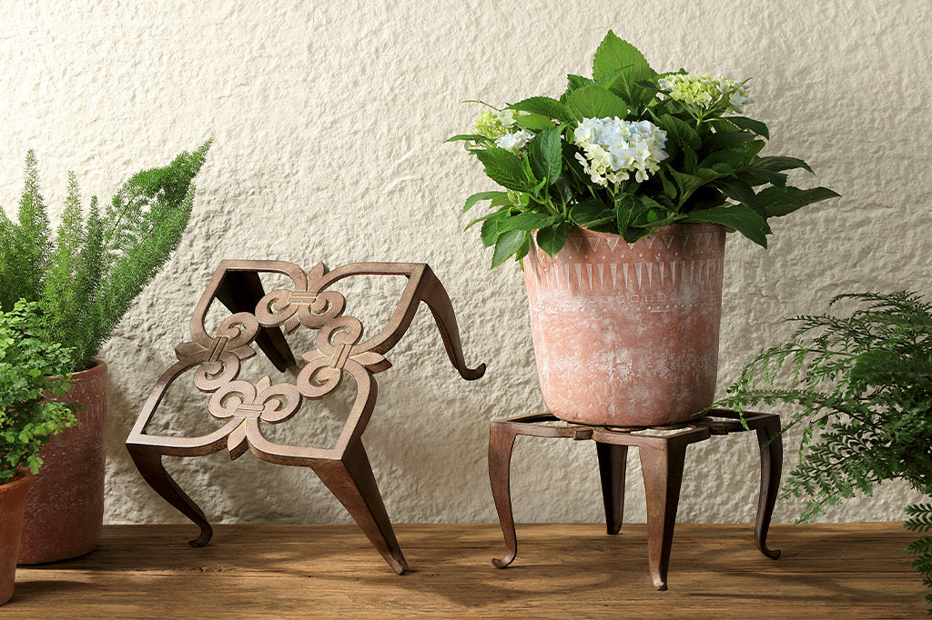 rustic brown finish on classic scrollwork design on pair of plant stands