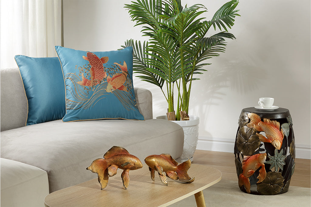 room with embroidered pillow, koi fish sculptures, and koi fish stool 