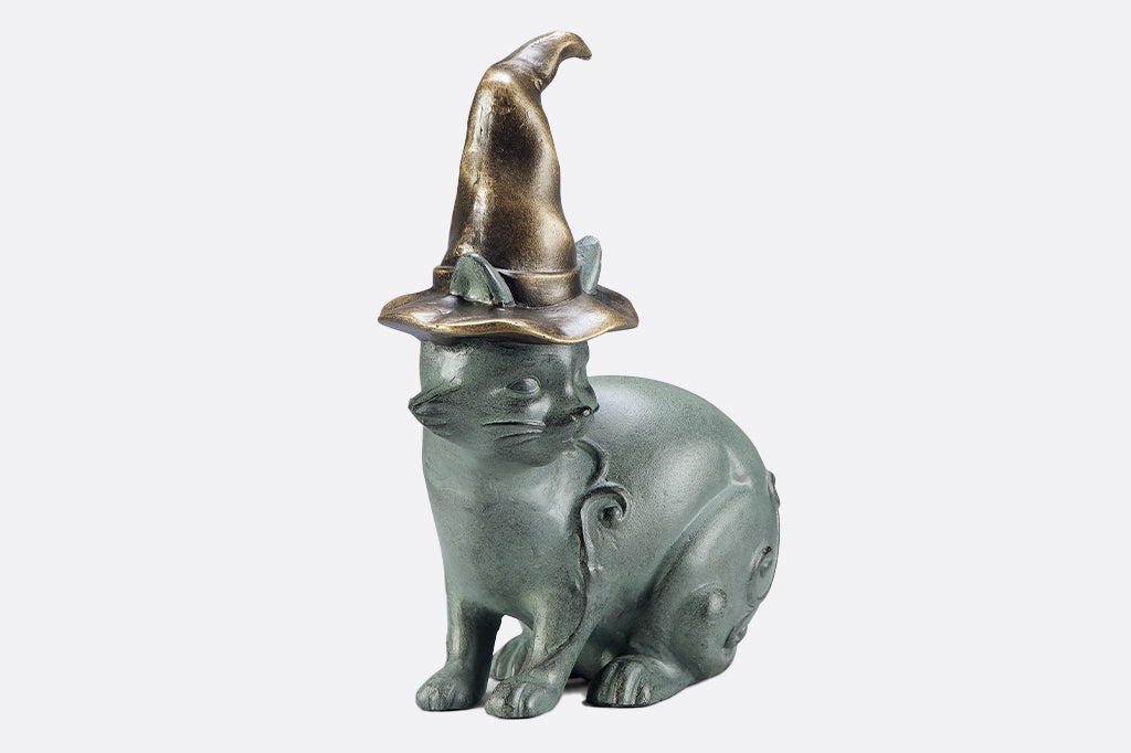 cast metal cat wearing witch hat garden sculpture 