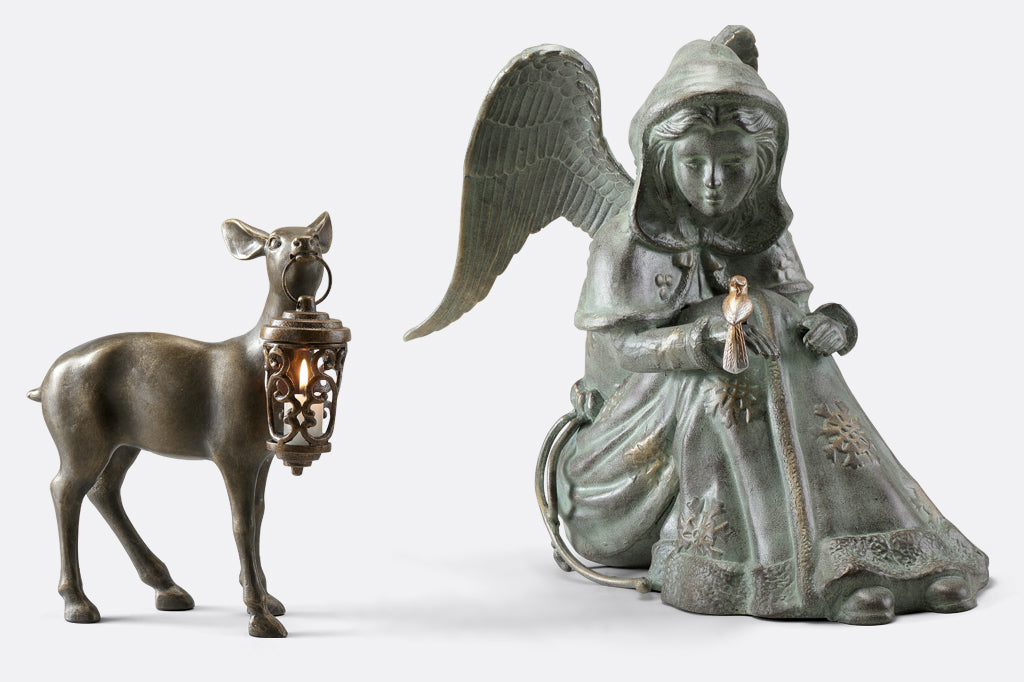 Cast Metal winter angel with bird on hand, with deer holding a lantern 