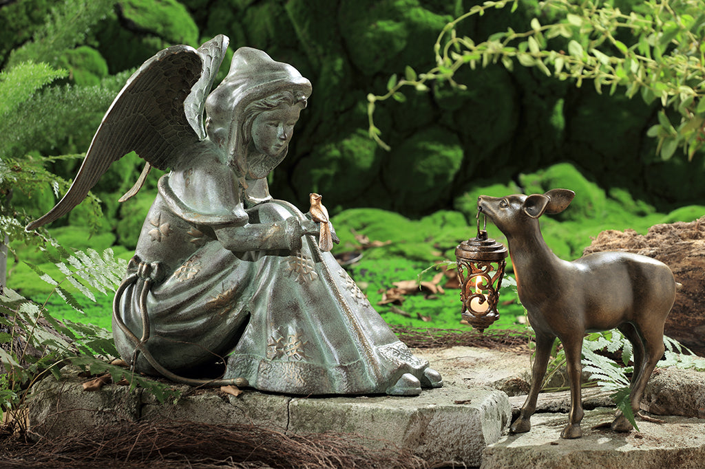 Cast Metal winter angel with bird on hand, with deer holding a lantern 