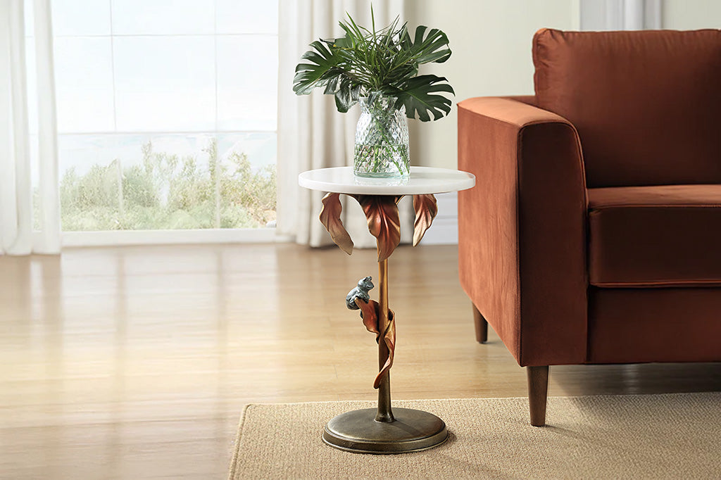 cast metal tropical drink table with white marble top featuring copper colored tropical leaves and a green frog balancing on a leaf - supports a white marble top