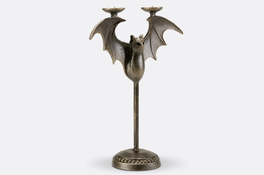 Cast metal bat tapper candle holder, face right