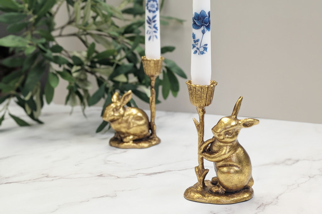 Cast metal gold bunny taper candle holders with blue and white floral candles