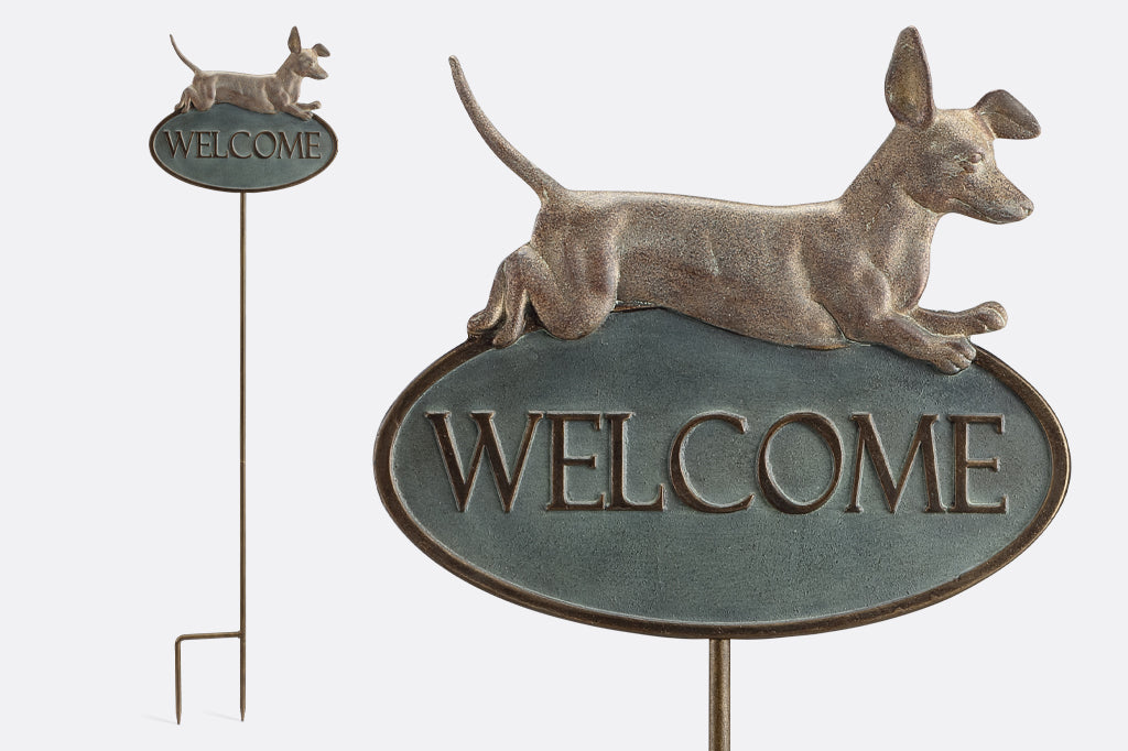 cast metal leaping Dachshund over the phrase welcome. Cast metal staked welcome sign that has a forked staked at base 