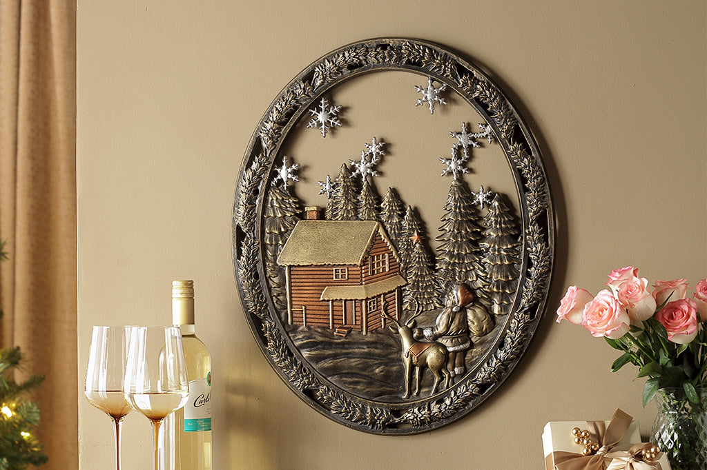 Cast metal circle wall art with pine trees, a cozy cabin, and santa with a present sack 