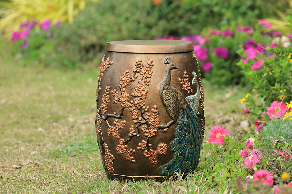 Cast Aluminum stool with storage space inside is shown in garden and features two peacocks entwined among flowering blossoms