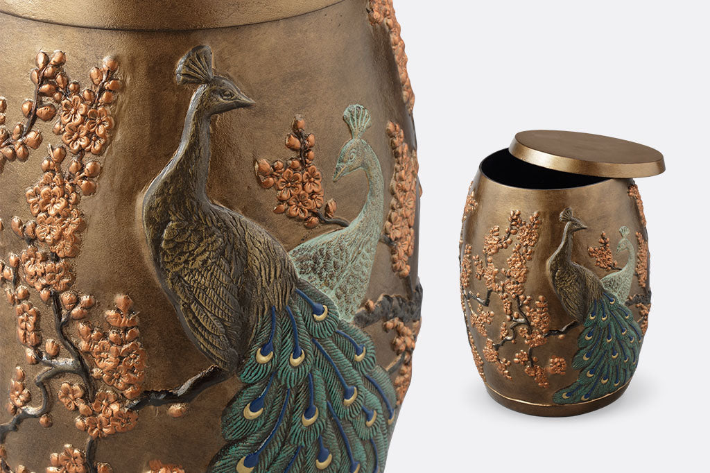 Cast Aluminum stool with storage space inside features two peacocks entwined among flowering blossoms. Close up view and shown with lid askew