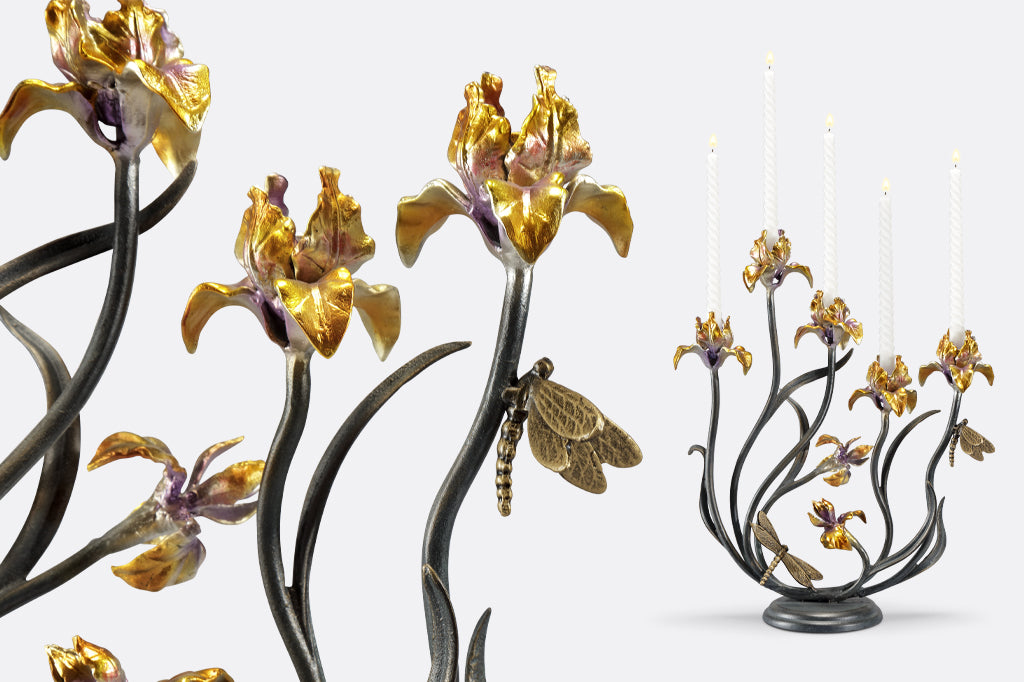 cast metal iris taper candelabra holding five tapers, irises are a delicate blend of yellow with purple. Dragonfly detailing on stem of flowers 