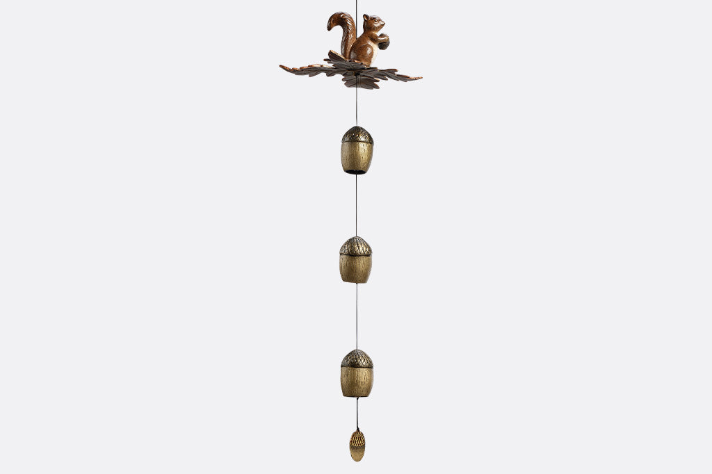 Decorative wind art with a squirrel and acorn design on a white background