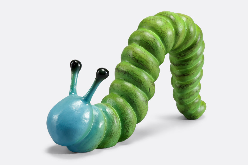 cast metal caterpillar with two antenna, colored in a lime green fading to a sky blue towards the head of caterpillar  