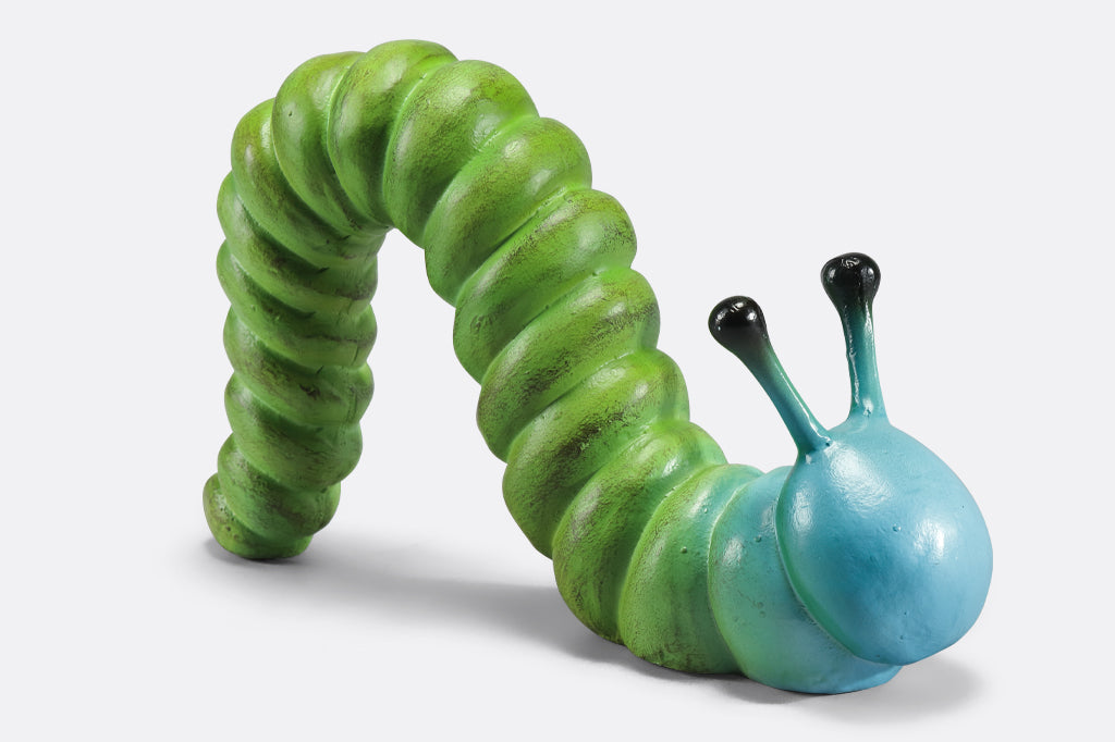 cast metal caterpillar with two antenna, colored in a lime green fading to a sky blue towards the head of caterpillar  