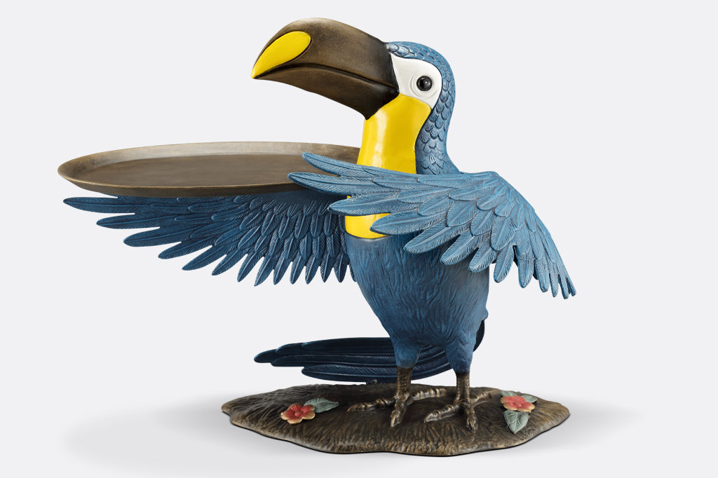 cast metal toucan holding a serving tray on wing, blue and yellow toucan 