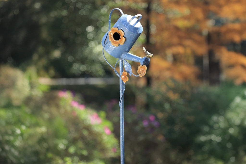blue sheet metal watering can with bird on spout and floral details birdhouse 