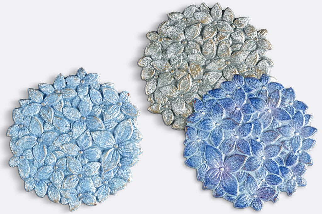 close up view of 3 coasters of blue hydrangea blossoms