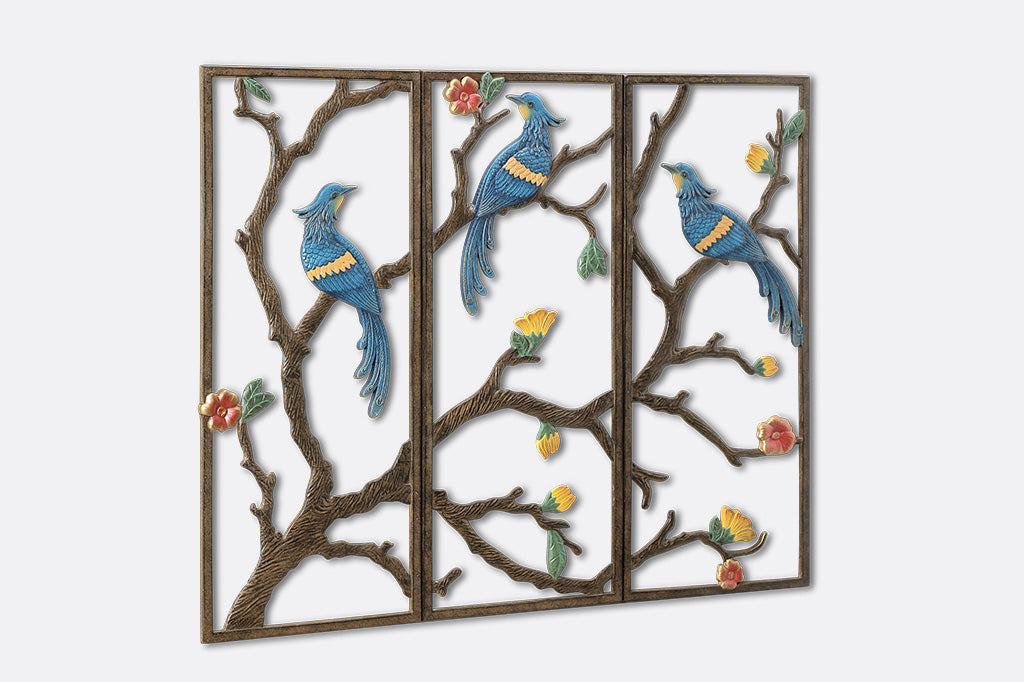Decorative wall art with birds and branches on a white background