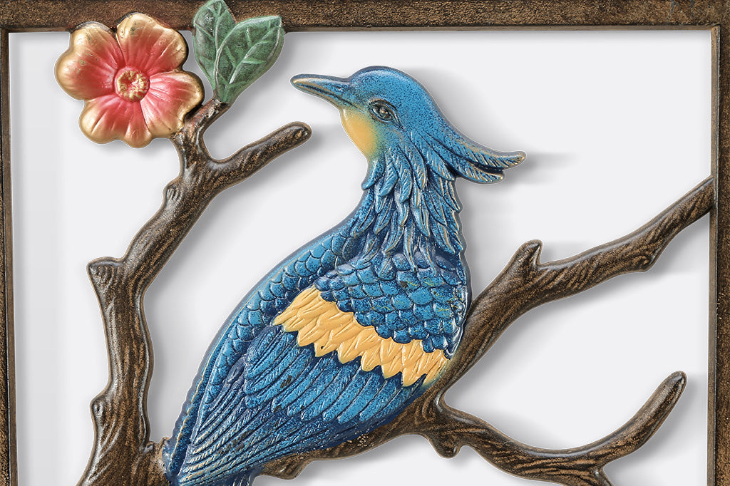 Decorative wall art with birds and branches on a white background