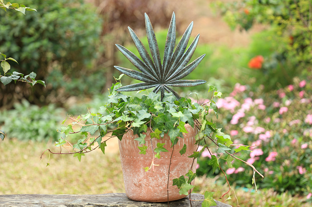 cast metal spiky leaf pot trellis set in planter with ivy 