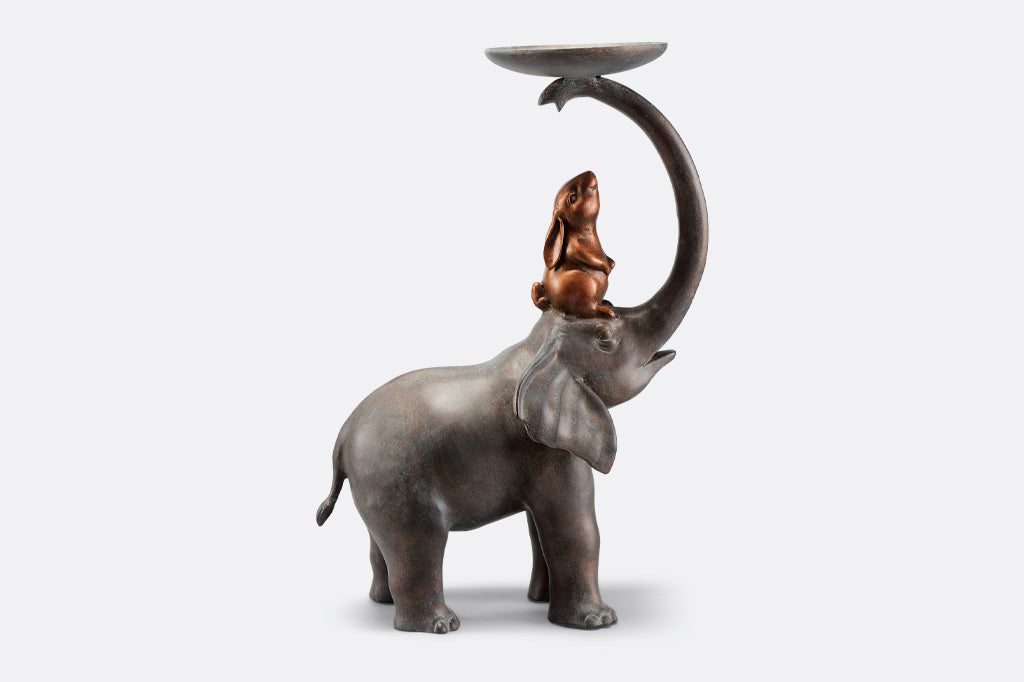 Garden Sculpture Plant Stand shows rabbit sitting on elephant's head, whose trunk holds a plant tray