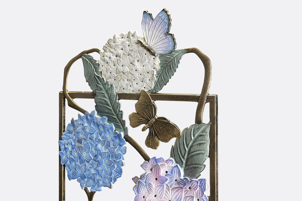 closeup view of Garden trellis with colored finish on both sides, features white, blue, and purple hydrangea blossoms with multi-hued butterfly accents.