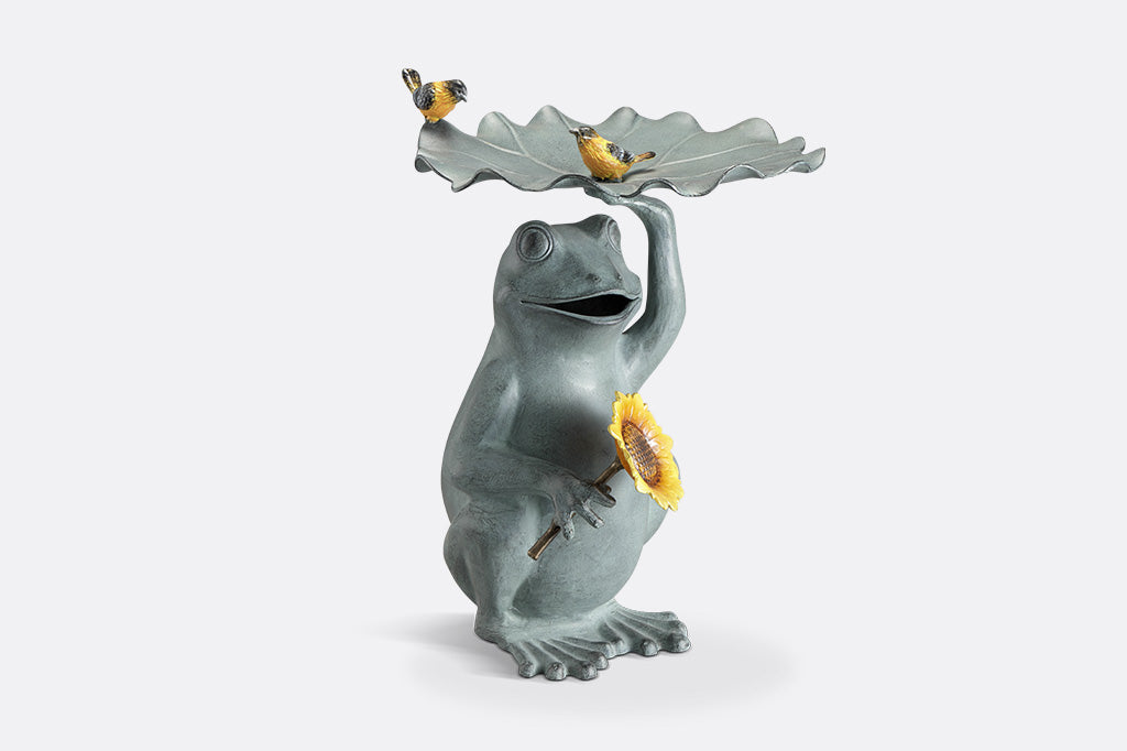 Birdbath that features a Frog holding a sunflower with yellow songbird accents on a lilypad basin.