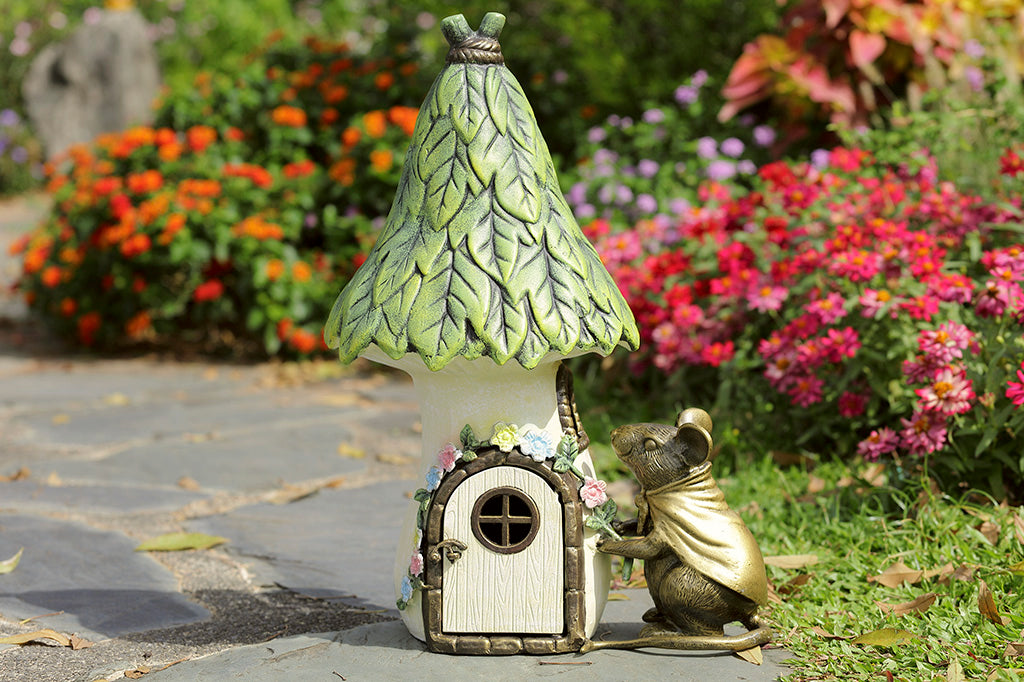 Garden candle lantern shaped like mouse and cottage - shown outside n garden path