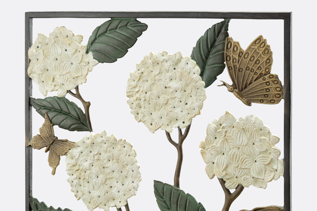 detail view of cast metal hydrangea and butterfly garden trellis. White hydrangea with cream highlights 