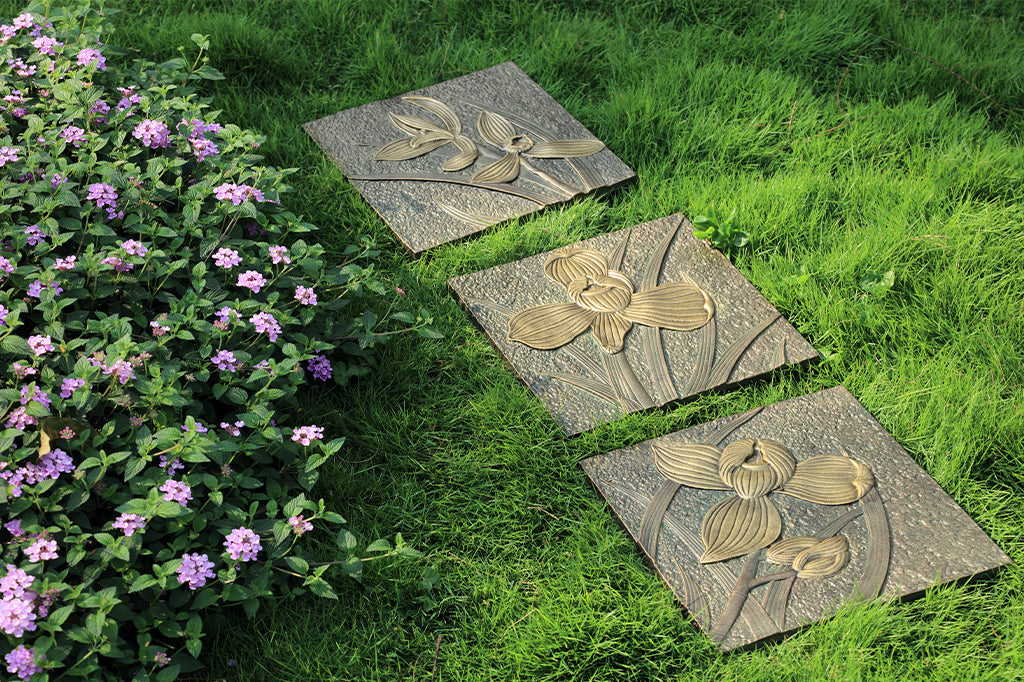 set of three orchid stepping stones set up as garden pathway 