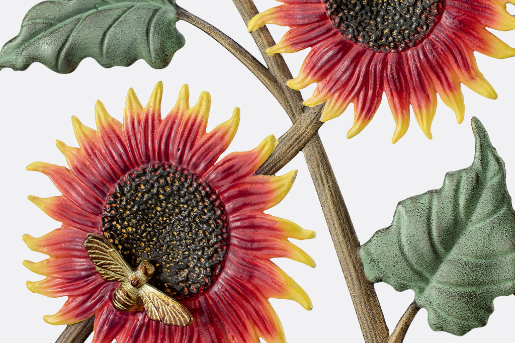 detail view of red/orange sunflowers with buzzing bees. notice the stippling detail of the sunflower center highlighted in gold and the branch texture of the sunflower stems 