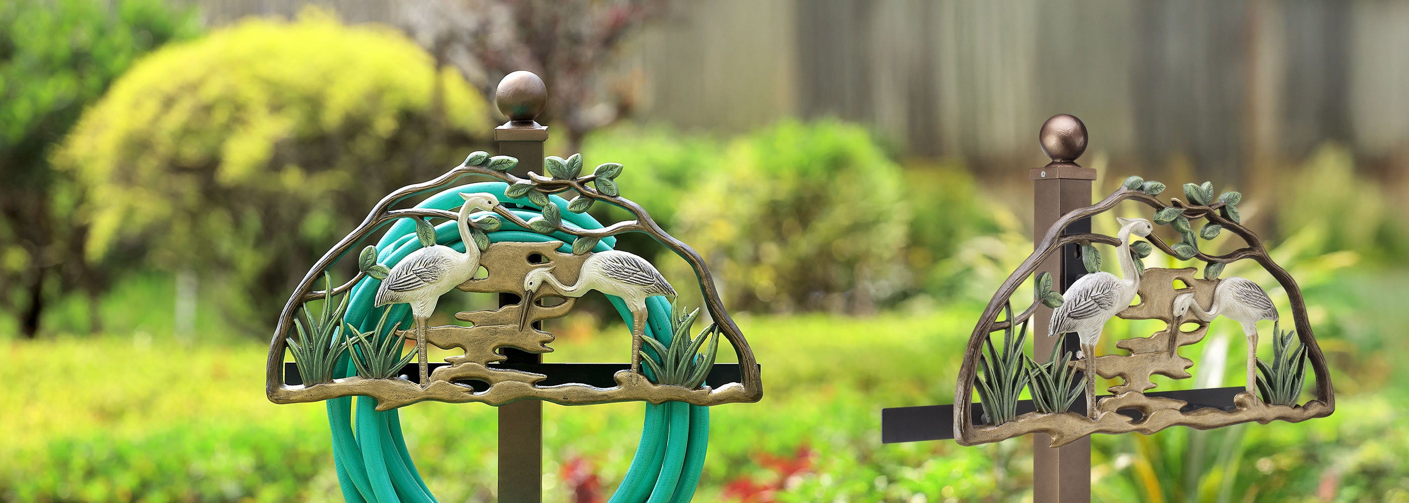 Decorative garden stakes with bird designs in a garden setting