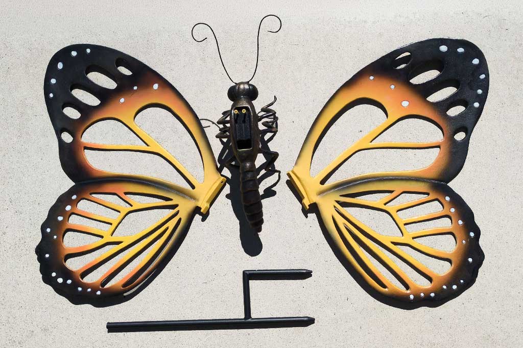 Metal butterfly sculpture on a textured surface - 4 parts require minimal assembly