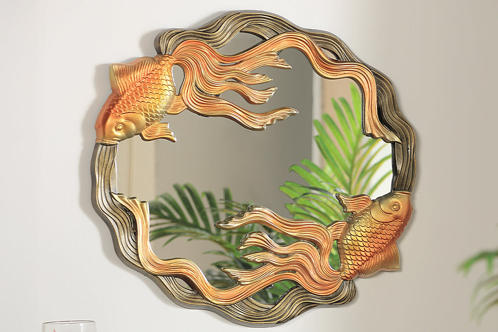cast metal golden koi fish swimming framing a circular mirror hung on wall 