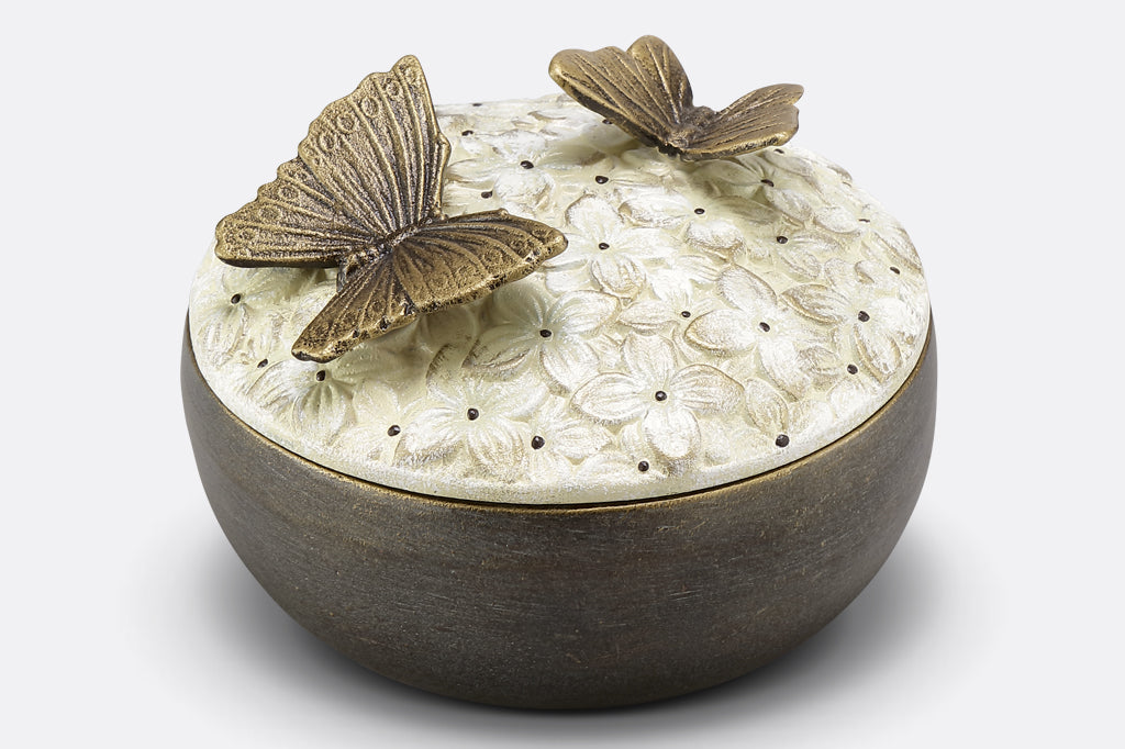 hydrangea box with floral pattern on lid and two bronze butterflies on top 