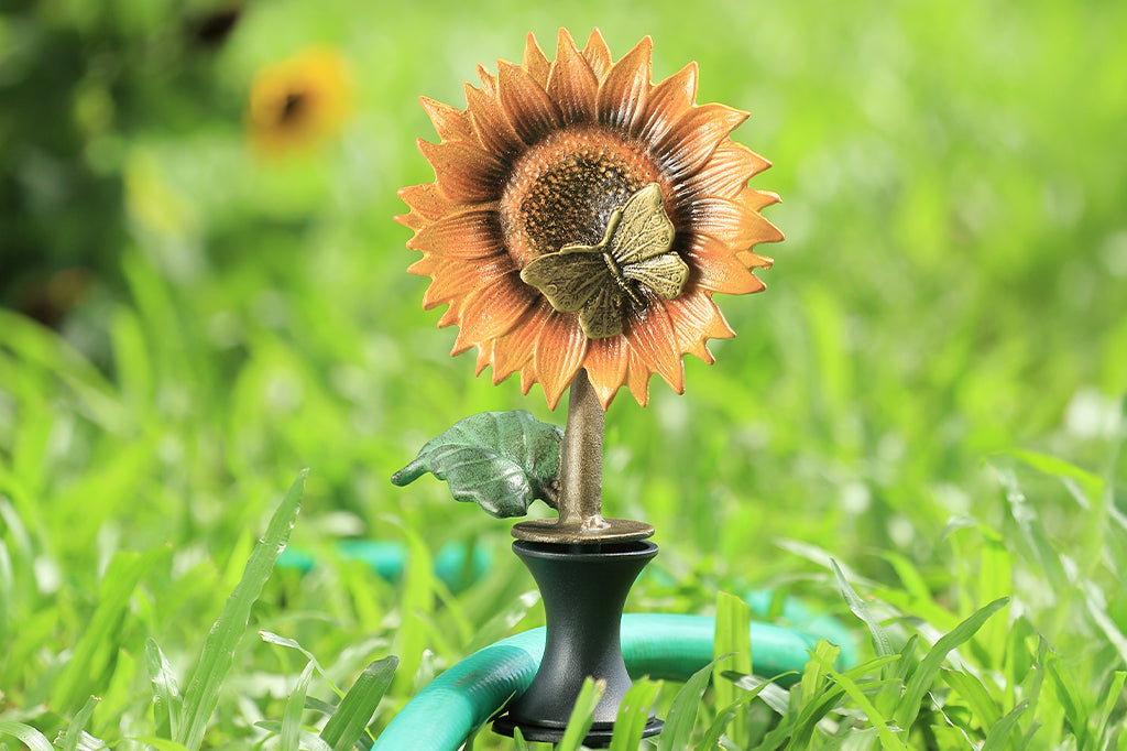 Cast metal yellow sunflower with butterfly in center hose guard 