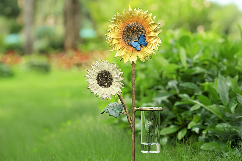 cast metal double sunflower one yellow on white, yellow sunflower with bleu butterfly in center. Cast metal rain catcher set in garden 