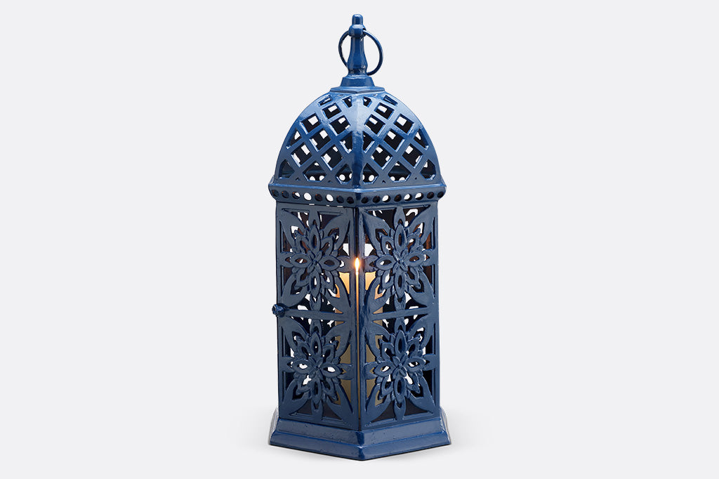 Moroccan inspired fretwork garden candle lantern with intricate patterns.