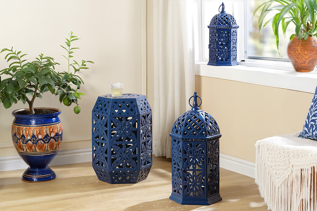 Decorative moroccan style blue lanterns, stool and Riviera planters in a room setting with a window and plant.
