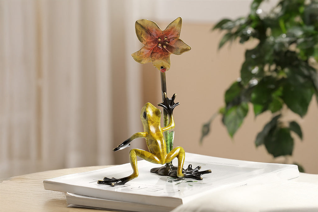 Frogs and flower figurine on a white background