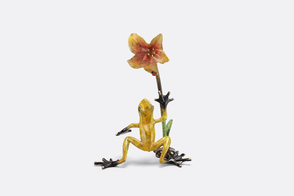 Frogs and flower figurine on a white background