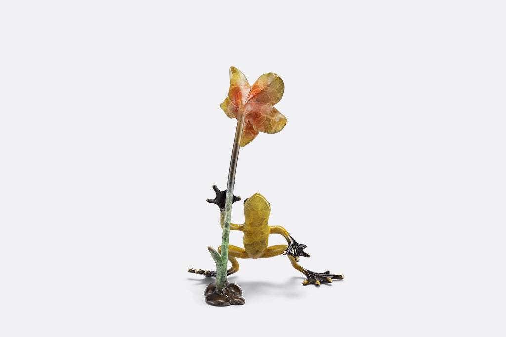 Frogs and flower figurine on a white background