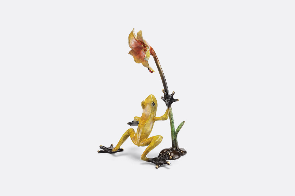 Frogs and flower figurine on a white background