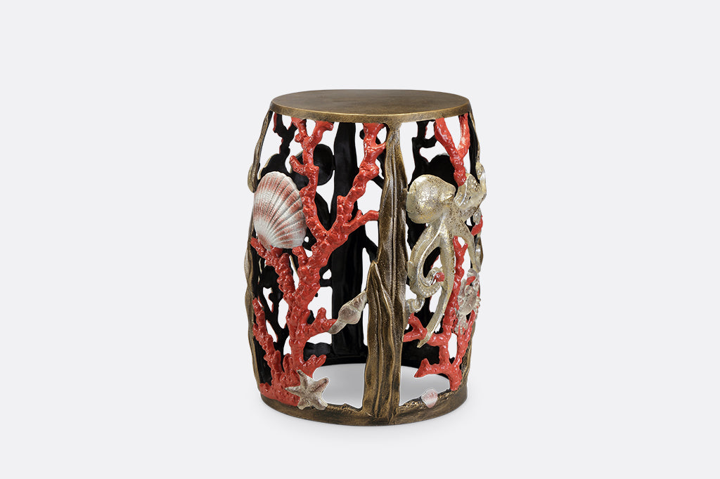 Garden stool featuring pink corals, an octopus, seashells, and crabs.