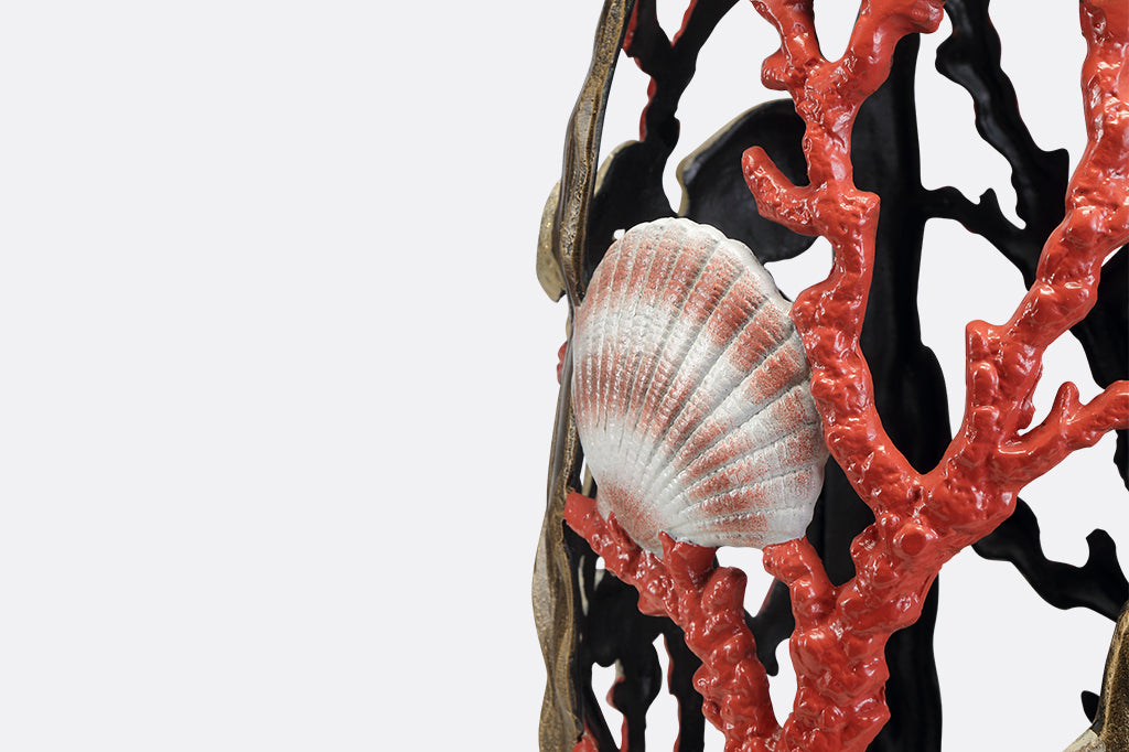 Garden stool featuring pink corals, an octopus, seashells, and crabs.