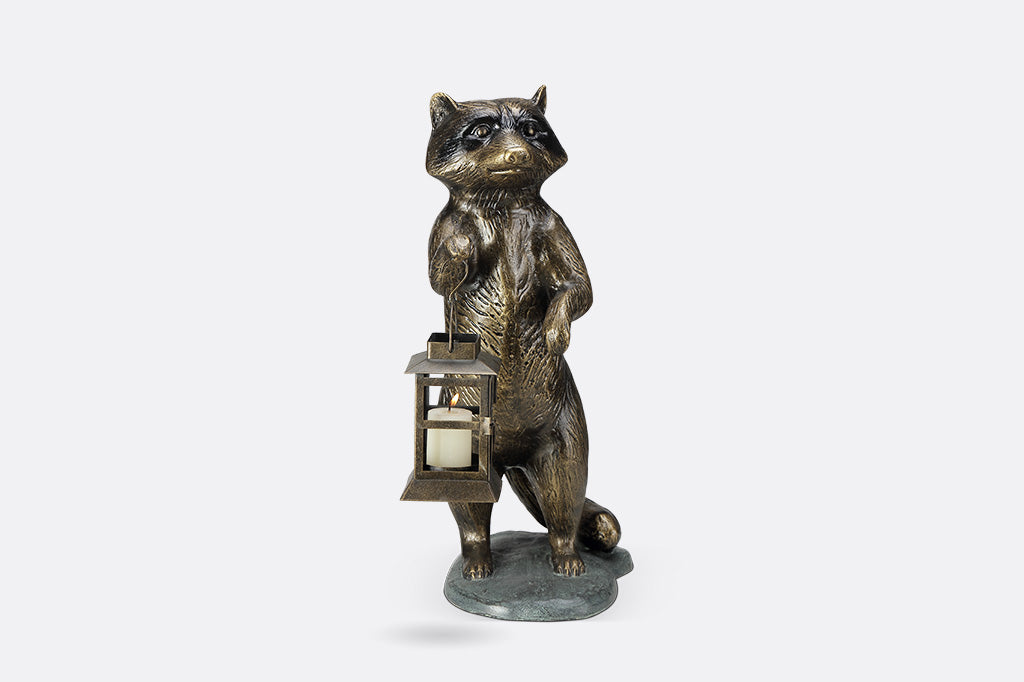Sculpture of a raccoon holding a lantern on a white background