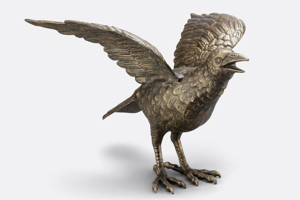 cast metal crow sculpture face right 