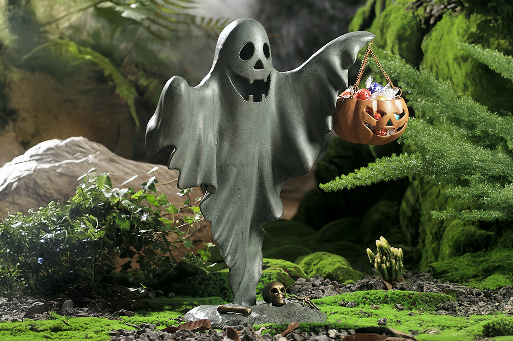 cast metal smiling ghost holding jack o lantern with candies inside  