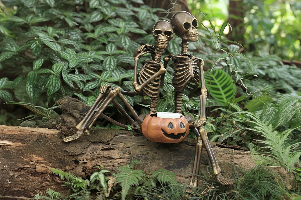 cast metal skeleton couple with jack o lantern with candle inside lantern 