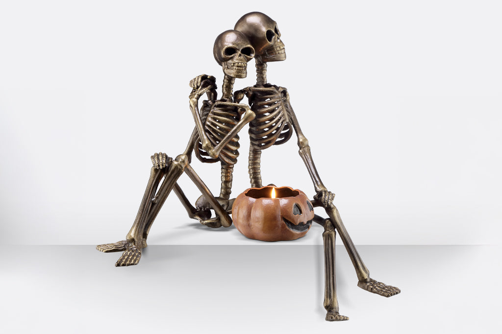 cast metal skeleton couple with jack o lantern 
