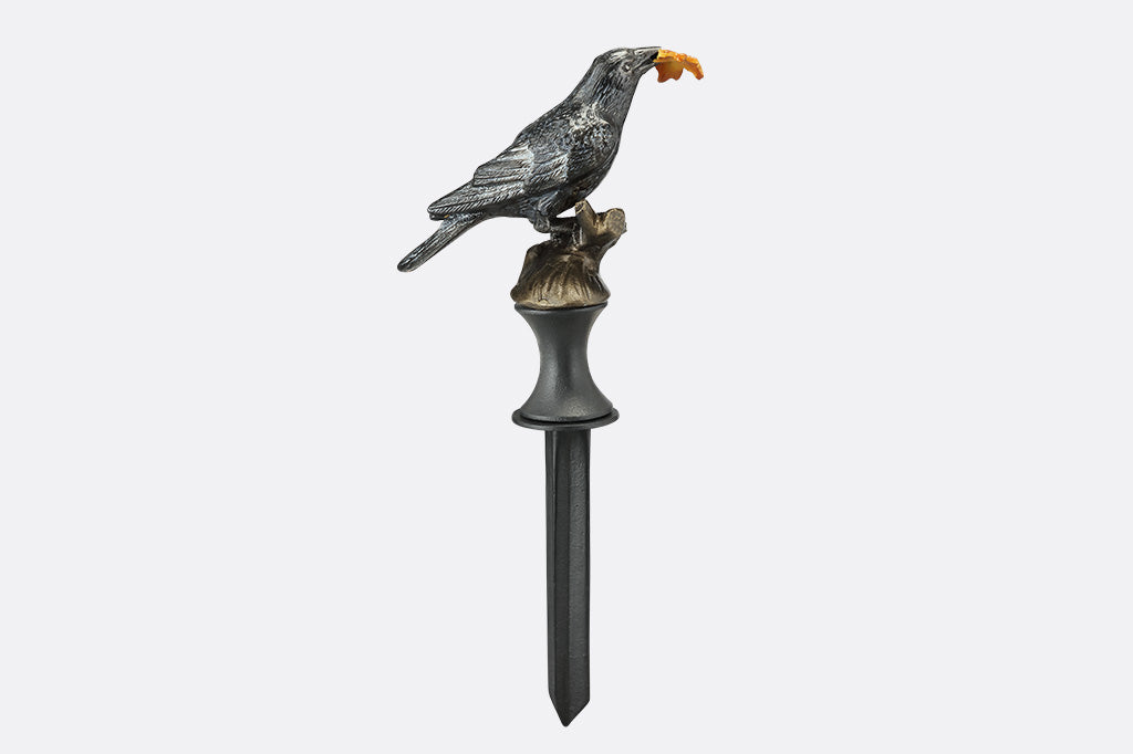 Decorative metal bird sculpture on a white background